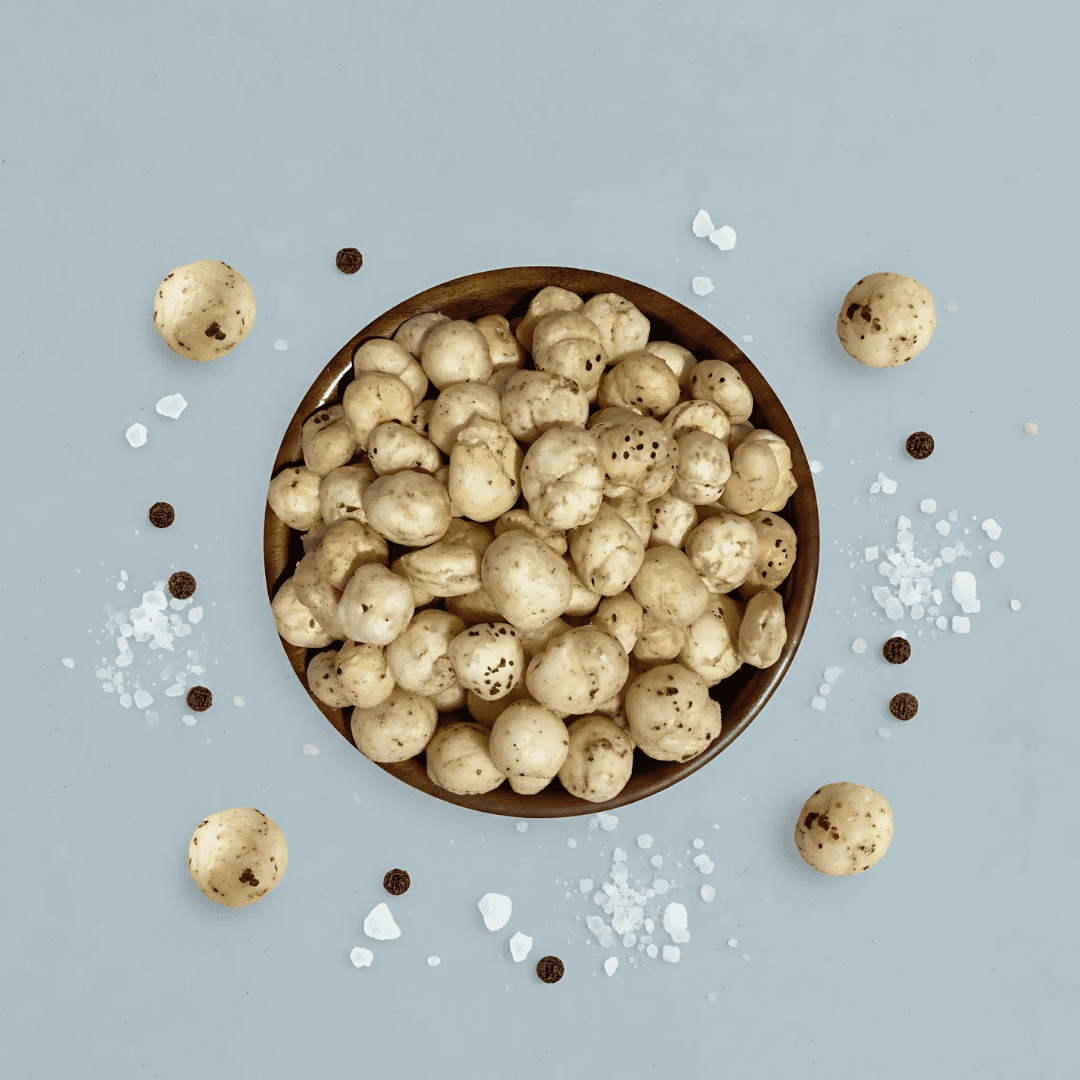 Premium photoshoot of Himalayan Salt & Black Pepper Makhana with seasoning accents